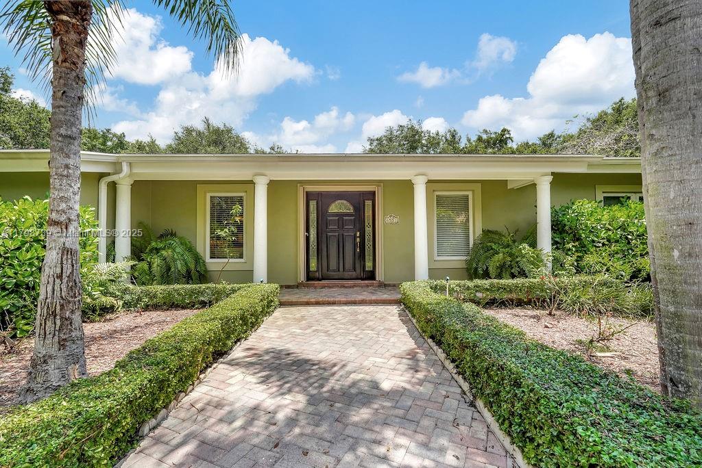 6551 Southwest 126th Street Pinecrest, FL 33156 - Photo 2 of 39 front view of a house with a garden