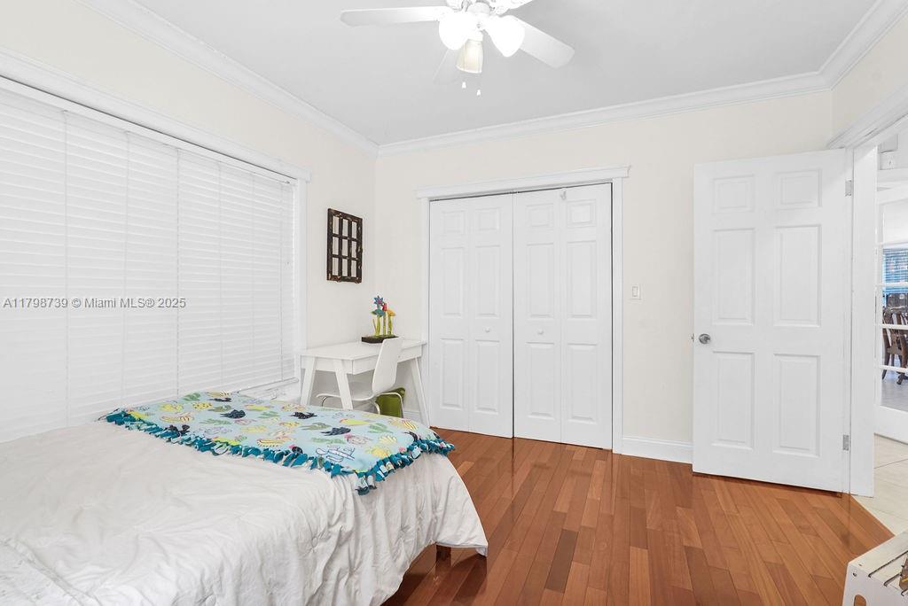 6551 Southwest 126th Street Pinecrest, FL 33156 - Photo 21 of 39 a bedroom with a bed and a chandelier