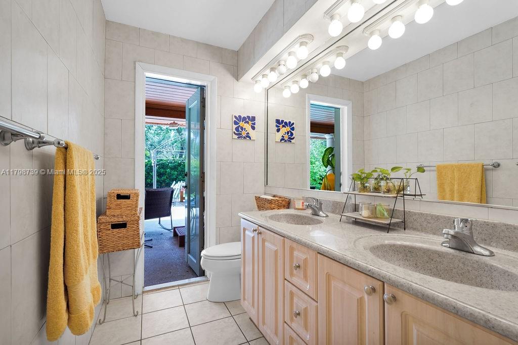 6551 Southwest 126th Street Pinecrest, FL 33156 - Photo 23 of 39 a bathroom with double vanity sink a mirror and a shower