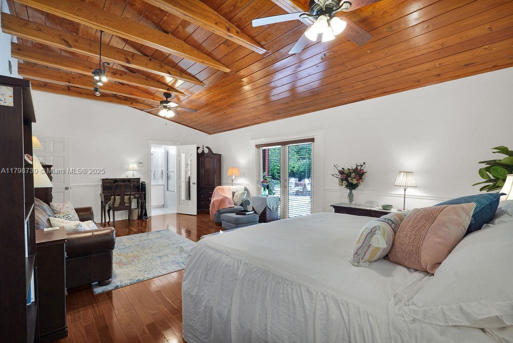 6551 Southwest 126th Street Pinecrest, FL 33156 - Photo 24 of 39 a bedroom with a bed a couch and potted plant with the outer view