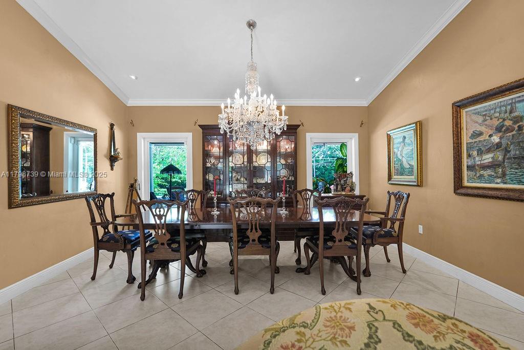6551 Southwest 126th Street Pinecrest, FL 33156 - Photo 30 of 39 a view of a dining room with furniture and chandelier