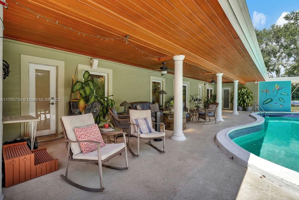 6551 Southwest 126th Street Pinecrest, FL 33156 - Photo 3 of 39 a view of a patio with table and chairs and potted plants