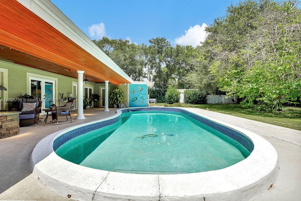 6551 Southwest 126th Street Pinecrest, FL 33156 - Photo 32 of 39 a view of swimming pool with outdoor seating