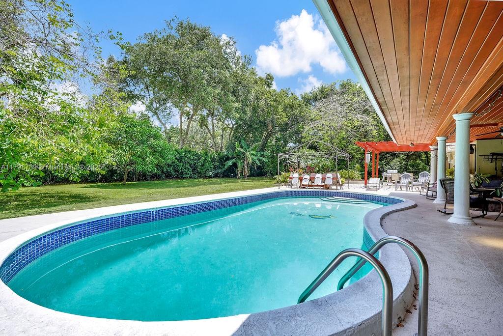 6551 Southwest 126th Street Pinecrest, FL 33156 - Photo 36 of 39 a view of a swimming pool with a patio