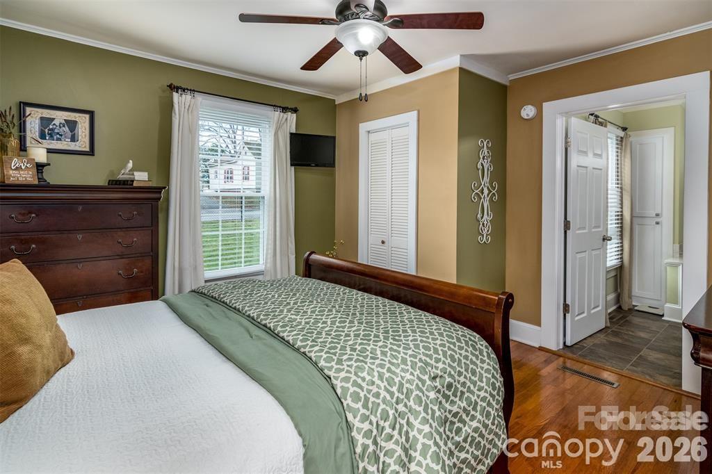 1004 Valley Street Kannapolis, NC 28081 - Photo 13 of 18 a bedroom with a large bed and a chandelier