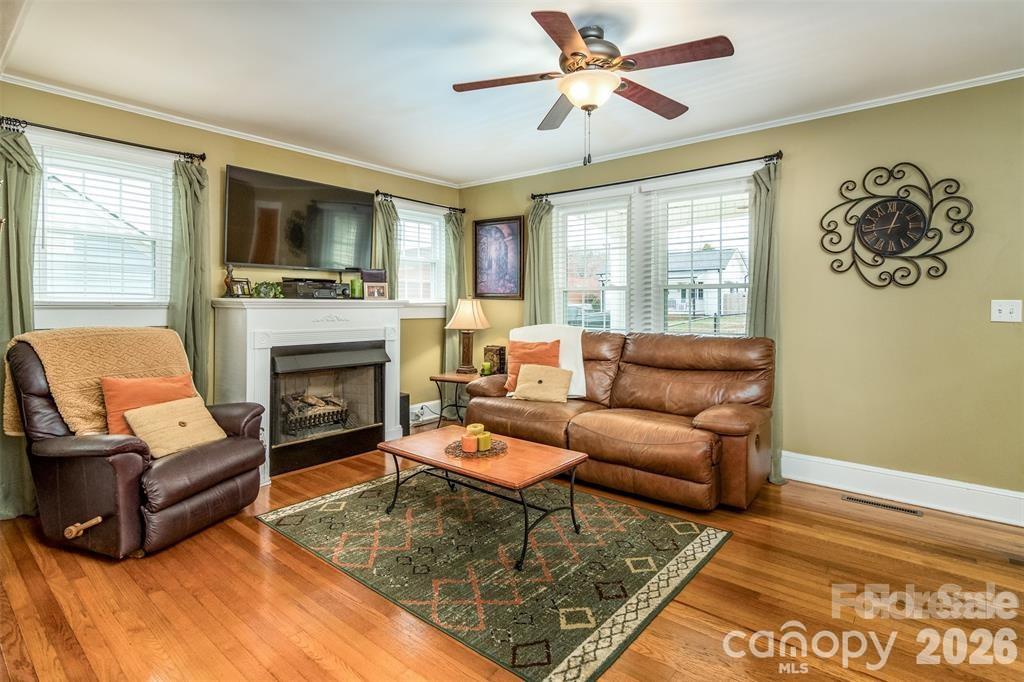 1004 Valley Street Kannapolis, NC 28081 - Photo 6 of 18 a living room with furniture a flat screen tv and a fireplace