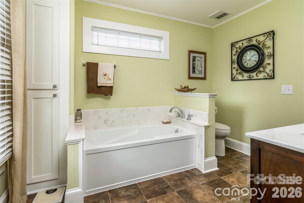 1004 Valley Street Kannapolis, NC 28081 - Photo 9 of 18 a bathroom with a sink a toilet and mirror