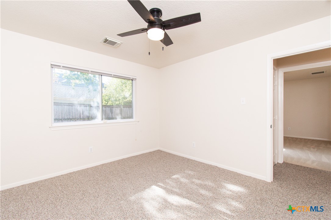 309 Ellis Street San Marcos, TX 78666 - Photo 13 of 18 an empty room with a window and a ceiling fan