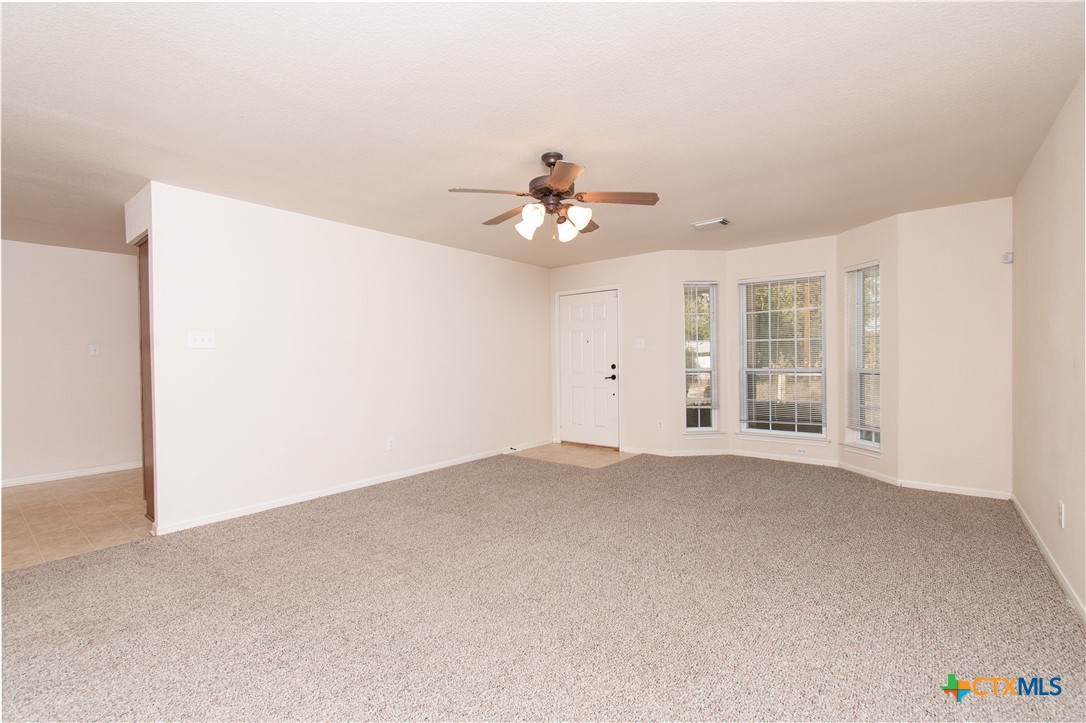 309 Ellis Street San Marcos, TX 78666 - Photo 4 of 18 an empty room with fan and windows