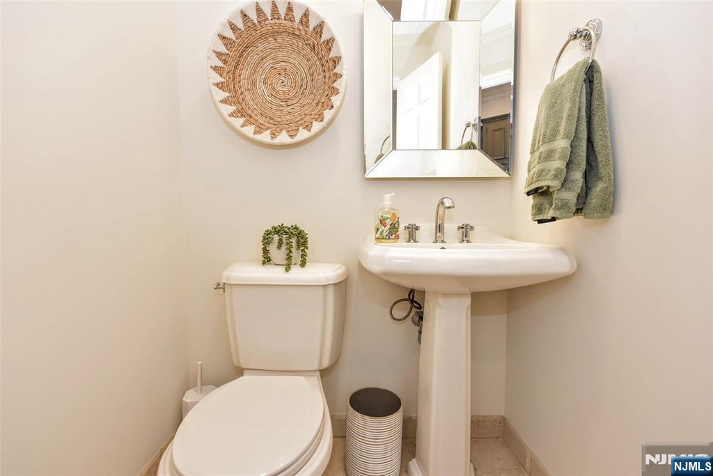 60 Dimmig Road Upper Saddle River, NJ 07458 - Photo 24 of 40 a bathroom with a sink mirror and toilet