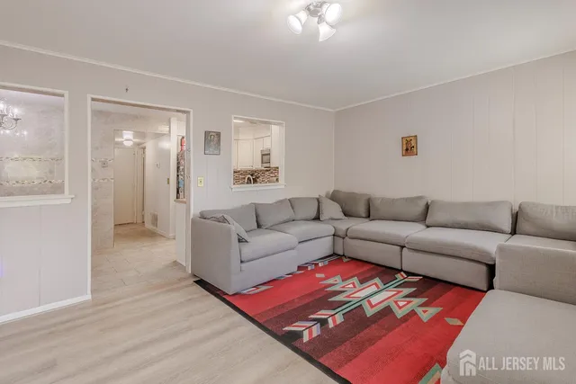 a living room with furniture and a rug