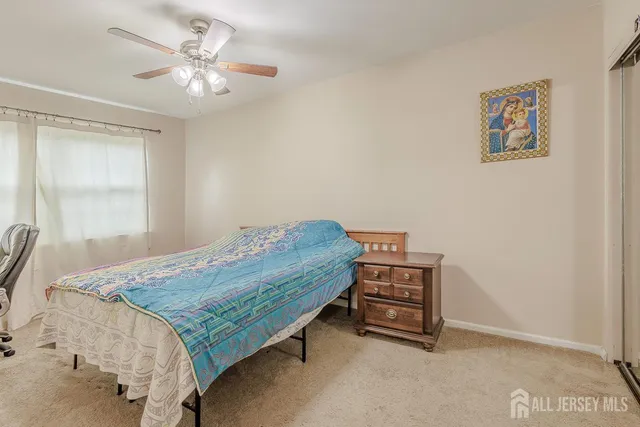 a bed sitting in a room next to a window