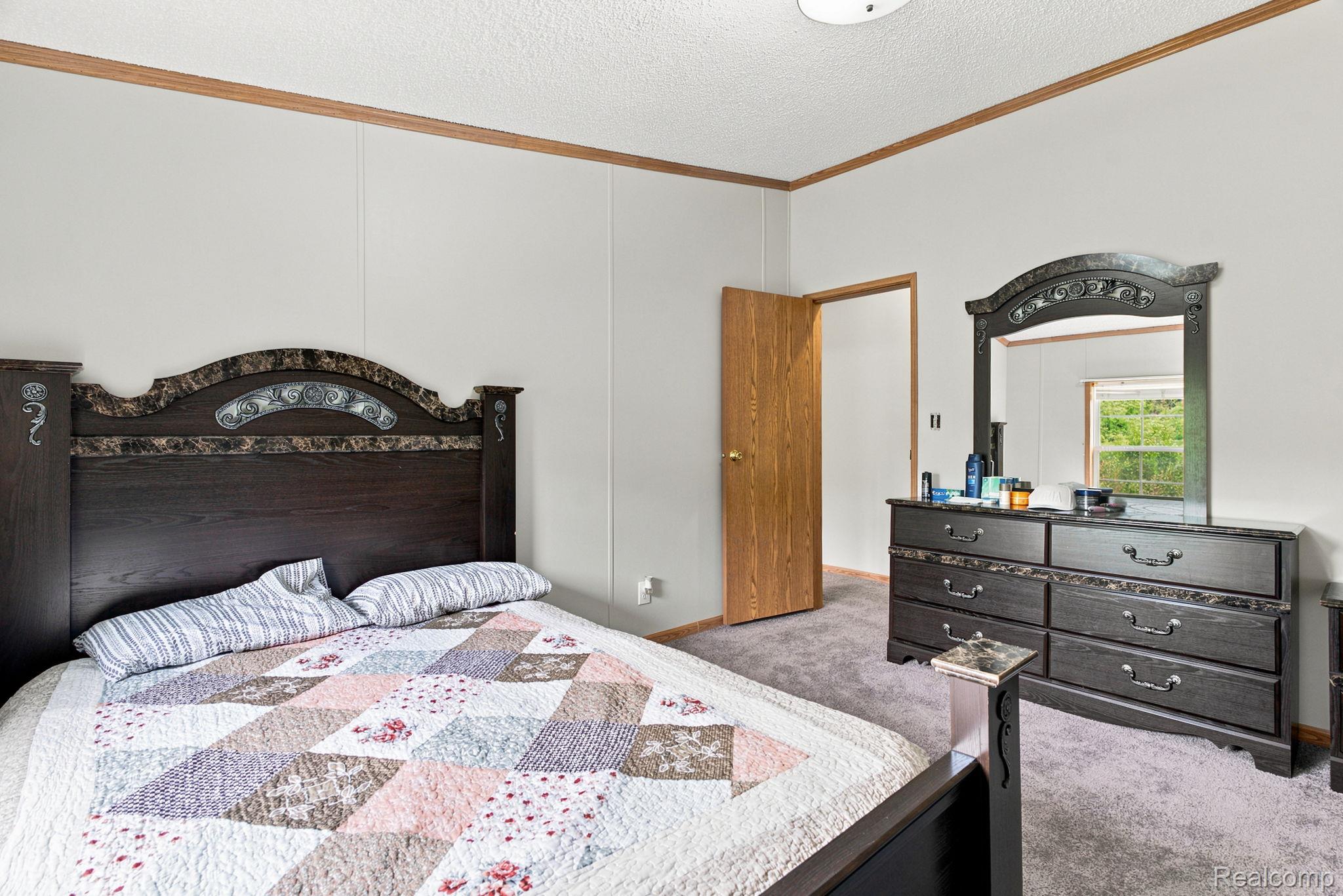 2390 Lakeshore Road Applegate, MI 48401 - Photo 26 of 97 Carpeted flooring, paneled walls, wood-finish trim, and a flush-mount ceiling light