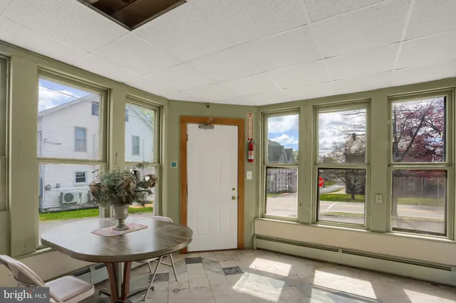 a living room with furniture and large windows