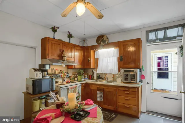 a kitchen that has a lot of cabinets in it and appliances