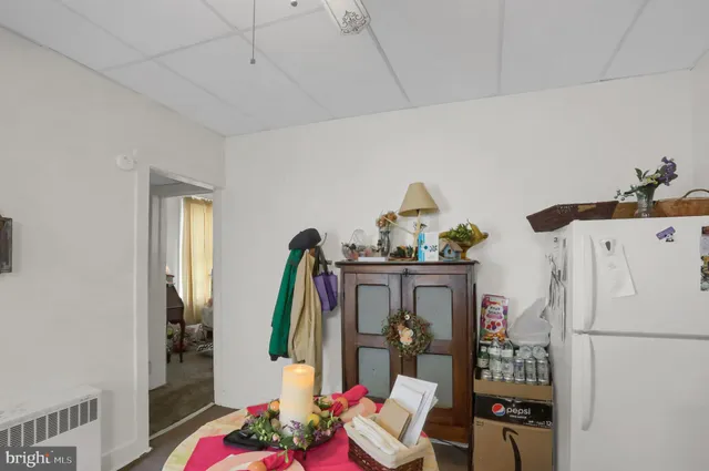 a utility room with refrigerator and washer