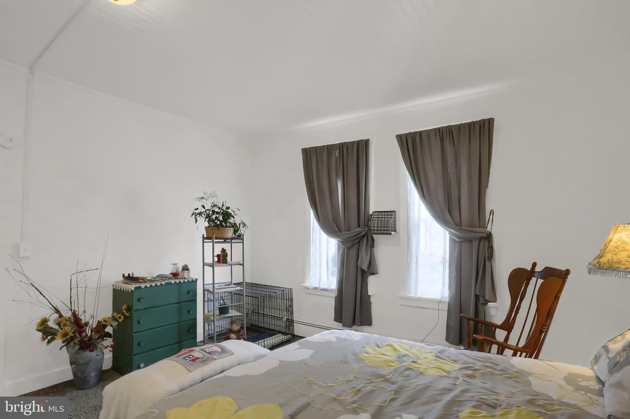 135 East Market Street Berrysburg, PA 17023 - Photo 21 of 45 a bedroom with a bed a potted plant and a sink