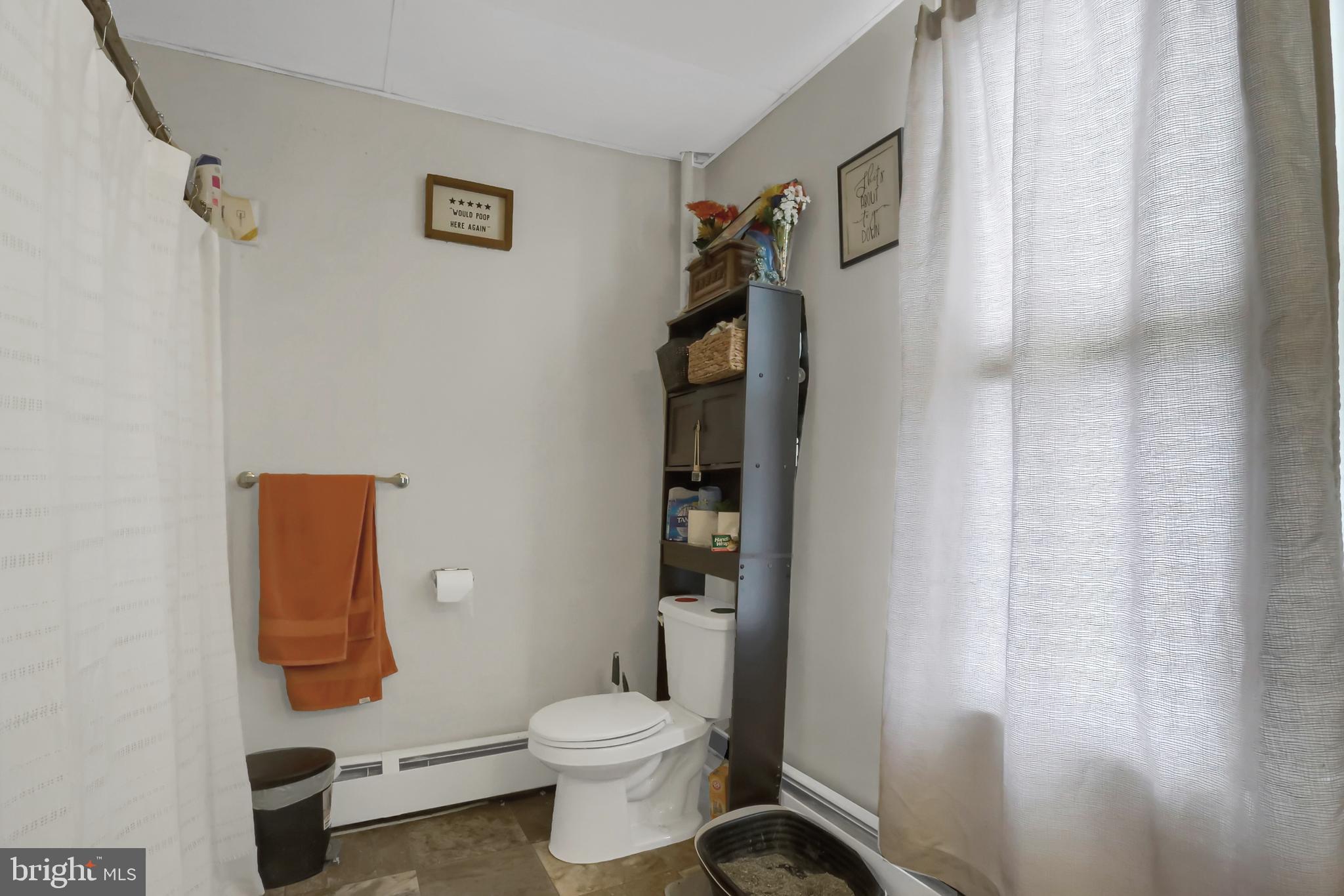 135 East Market Street Berrysburg, PA 17023 - Photo 24 of 45 a bathroom with a toilet and a shower curtain