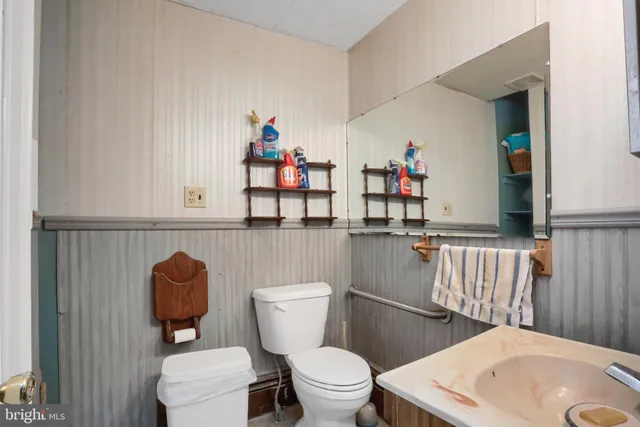 a view of a kitchen area with furniture and wooden floor