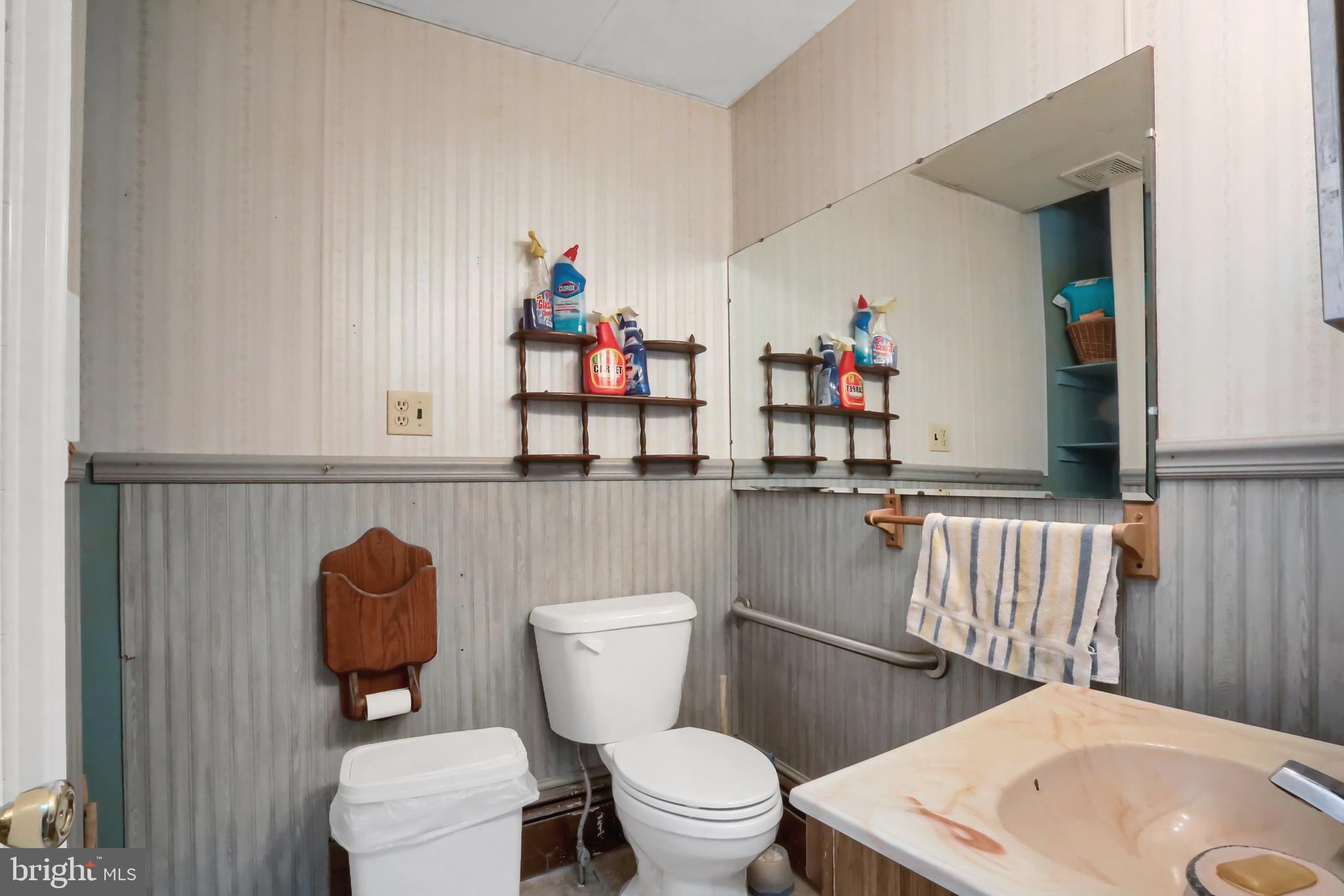 135 East Market Street Berrysburg, PA 17023 - Photo 30 of 45 a bathroom with a toilet a sink and a mirror