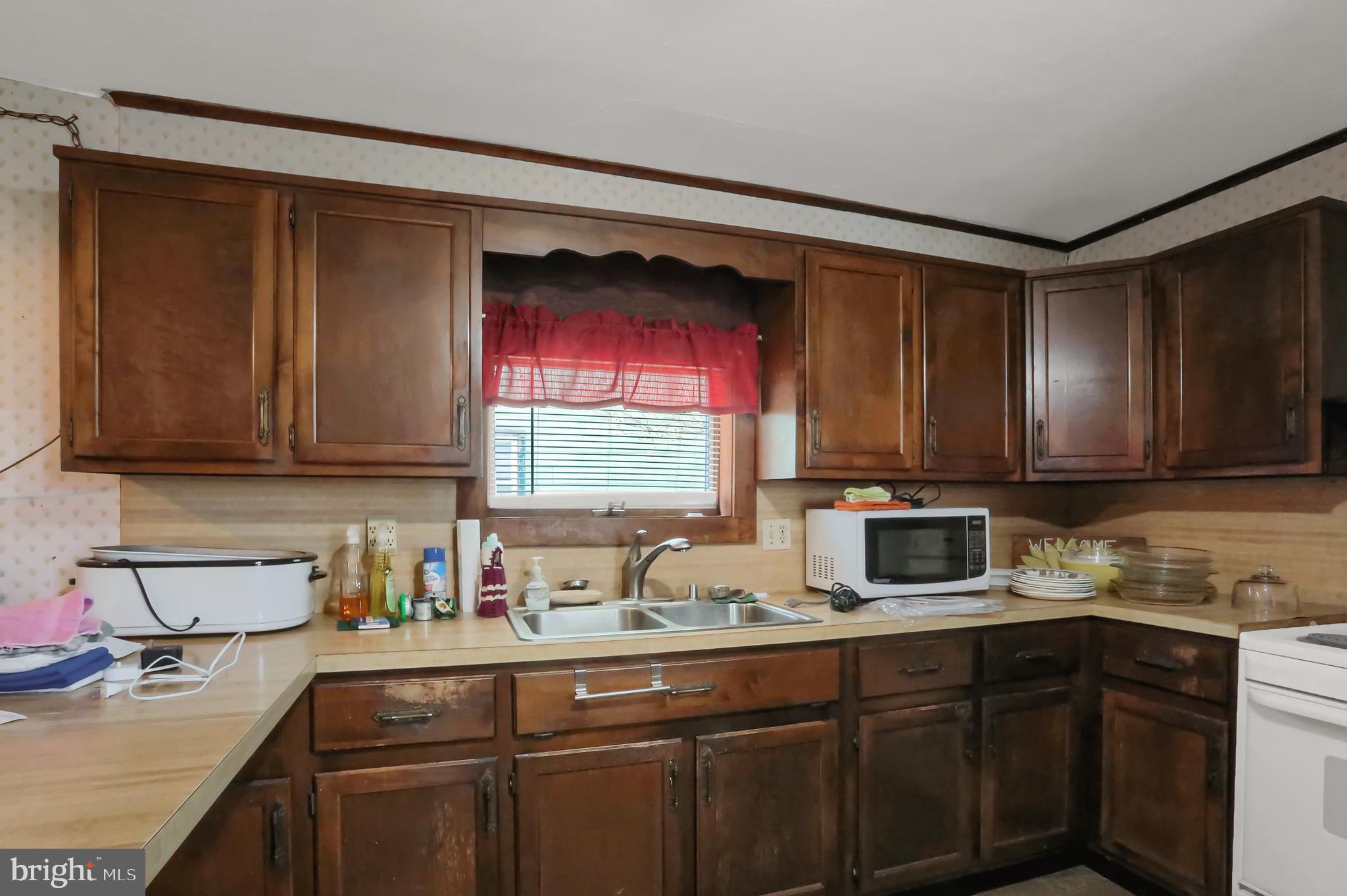 135 East Market Street Berrysburg, PA 17023 - Photo 33 of 45 a kitchen with stainless steel appliances granite countertop a sink stove and cabinets