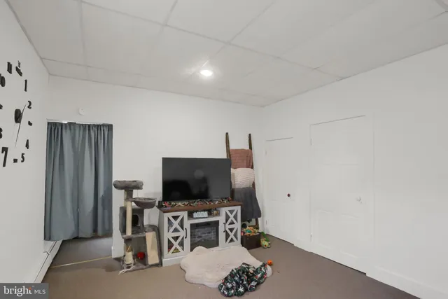 a living room with furniture and a ceiling fan