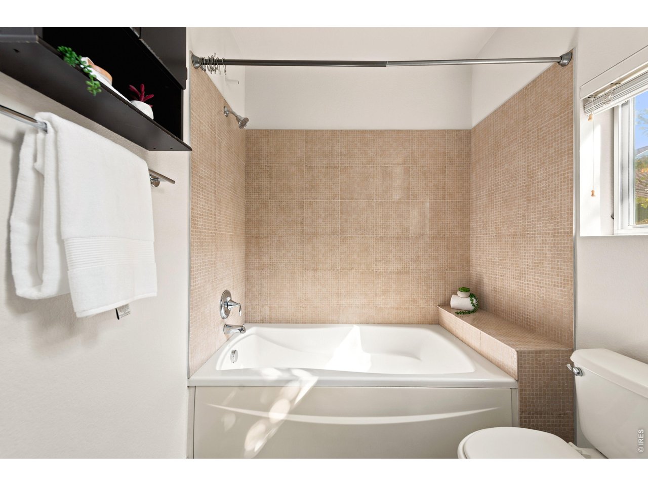 3033 Blake Street, Unit 112 Denver, CO 80205 - Photo 19 of 28 a bathroom with a toilet and a bathtub