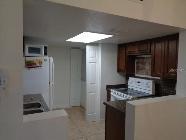 a kitchen with stainless steel appliances a stove a microwave and a refrigerator