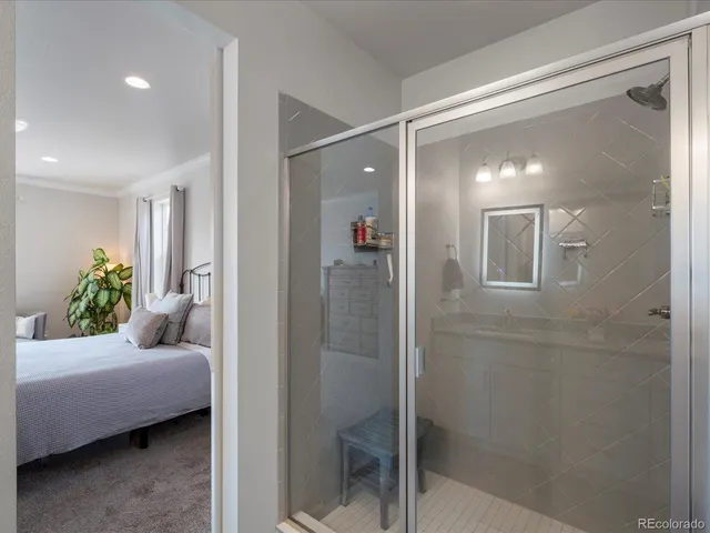 a en suite bathroom with a shower and a mirror