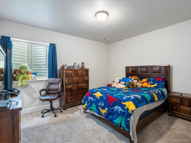 a bedroom with furniture and a flat screen tv