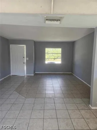 a view of an empty room and window