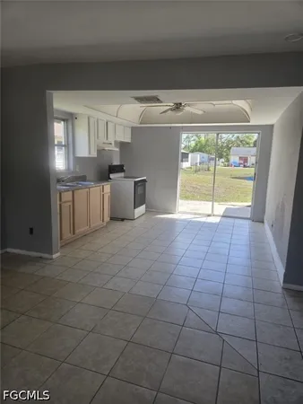 a view of a kitchen with furniture and an empty room