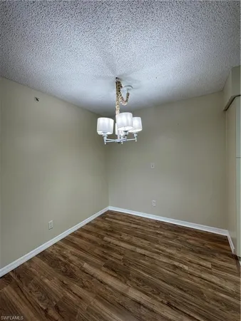 a view of a room with wooden floor cabinets and a ceiling fan