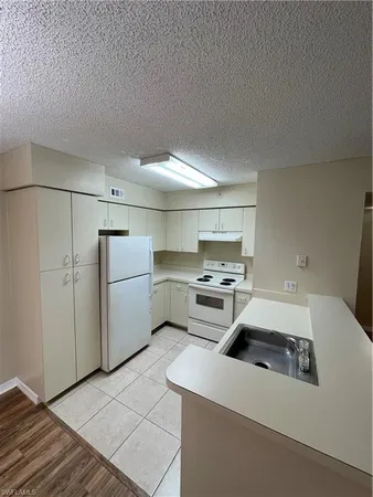 a kitchen that has a sink and a stove