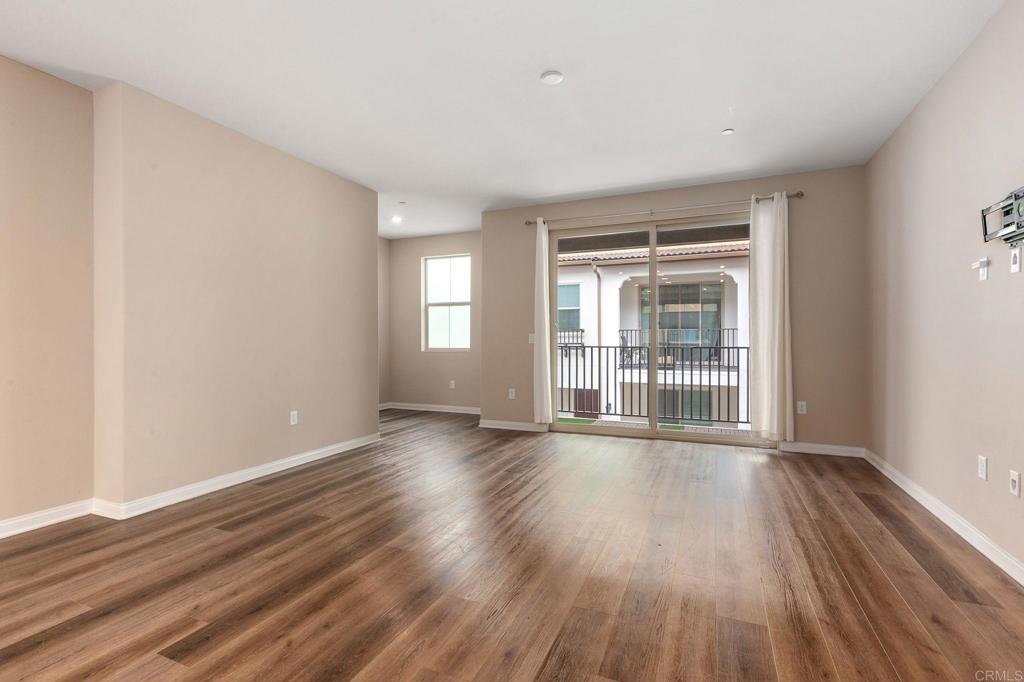 1771 Laurelwood Way Oceanside, CA 92056 - Photo 19 of 46 a view of an empty room with wooden floor and a window