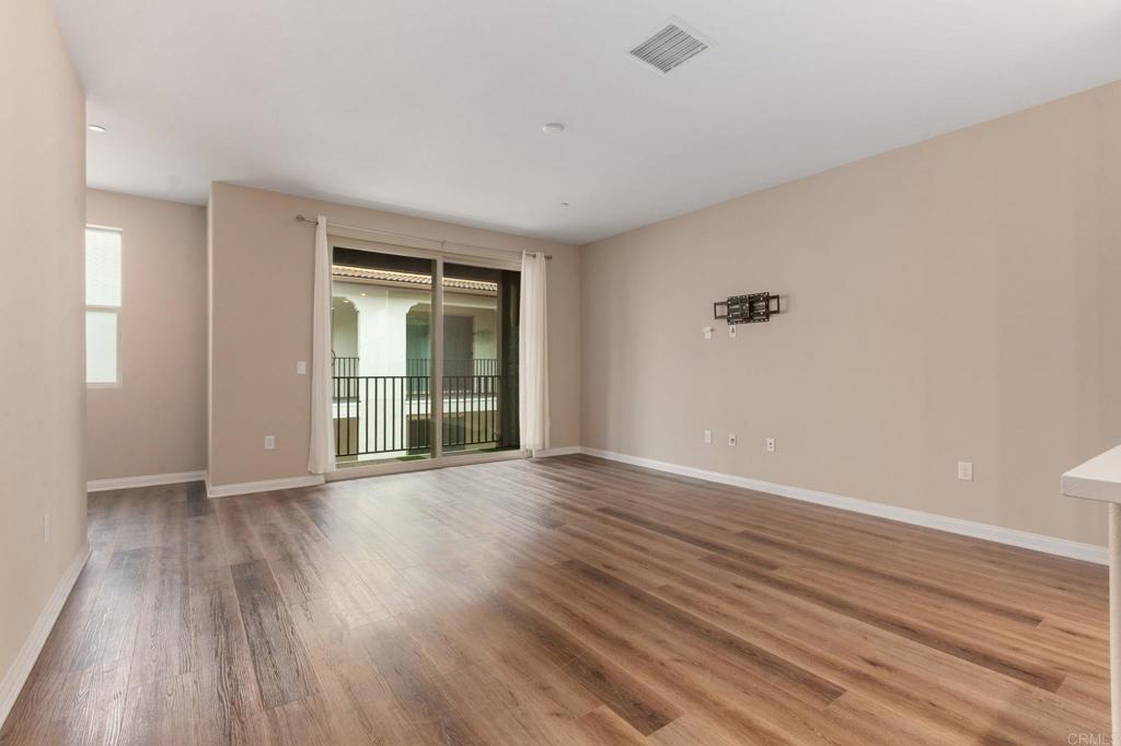 1771 Laurelwood Way Oceanside, CA 92056 - Photo 20 of 46 a view of an empty room with wooden floor and a window