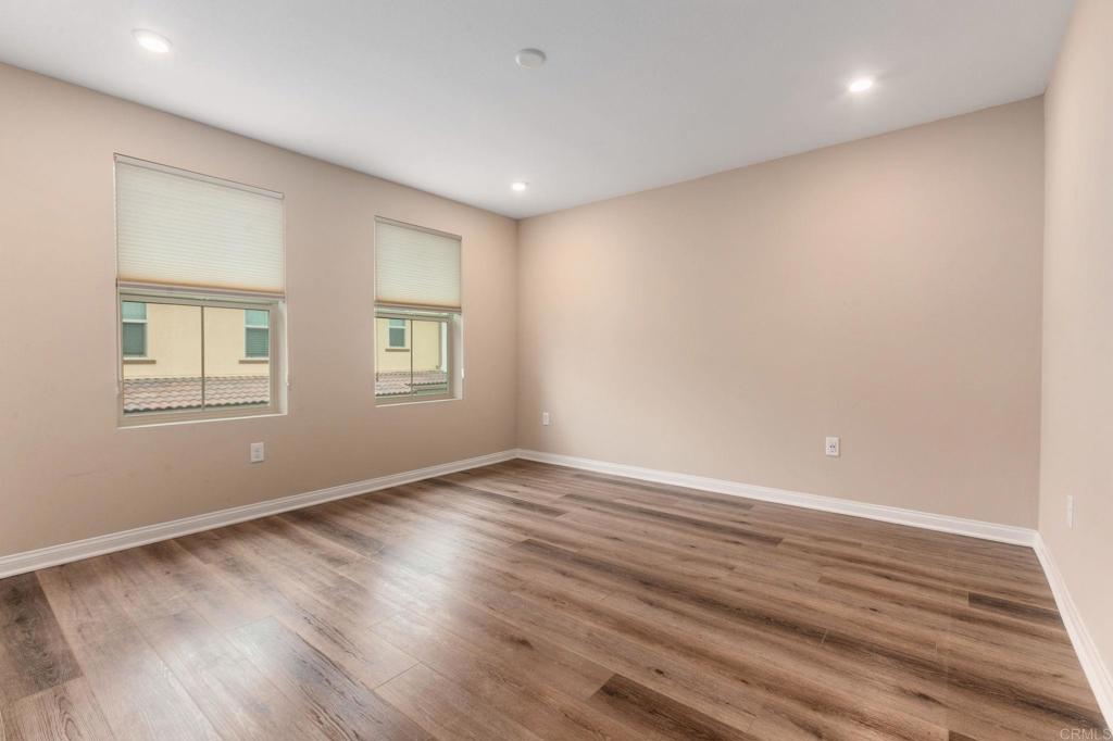 1771 Laurelwood Way Oceanside, CA 92056 - Photo 25 of 46 a view of an empty room with wooden floor and a window