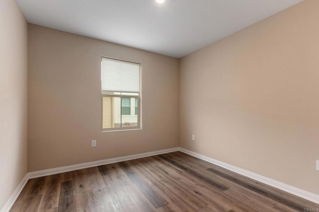 1771 Laurelwood Way Oceanside, CA 92056 - Photo 33 of 46 an empty room with wooden floor and windows