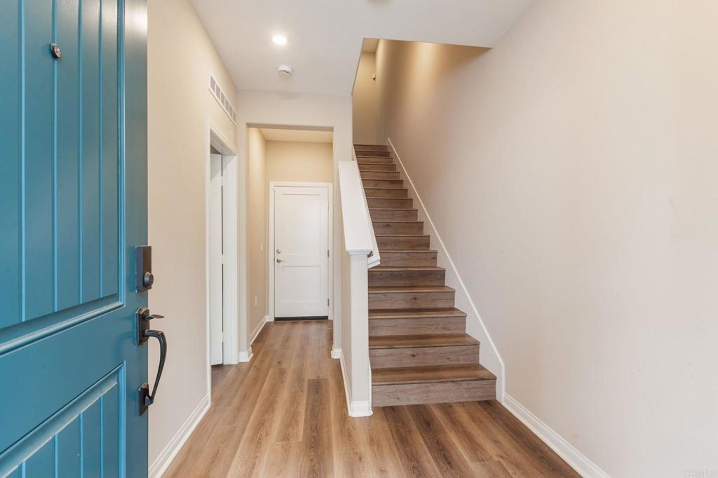 1771 Laurelwood Way Oceanside, CA 92056 - Photo 5 of 46 a view of a hallway with wooden floor and staircase