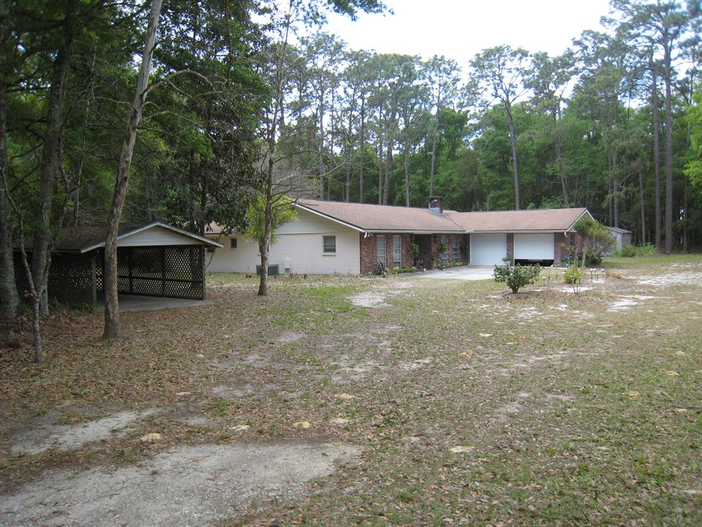 7130 Southwest 80th Street Ocala, FL 34476 - Photo 1 of 1 a front view of a house with a yard
