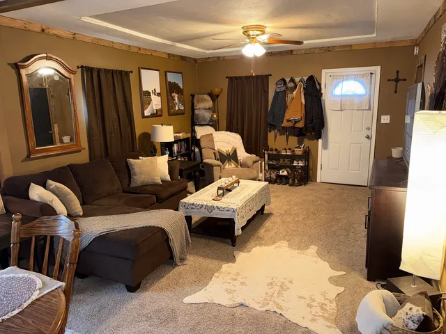 a living room with furniture and a gym machine