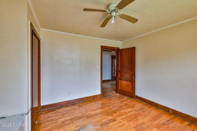 a view of hallway with a ceiling fan