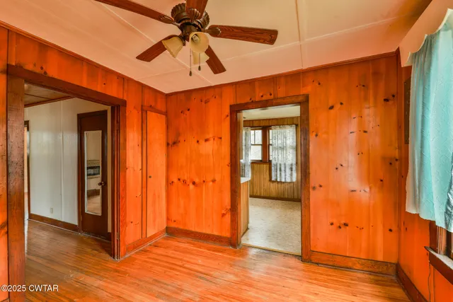 an empty room and wooden door with windows