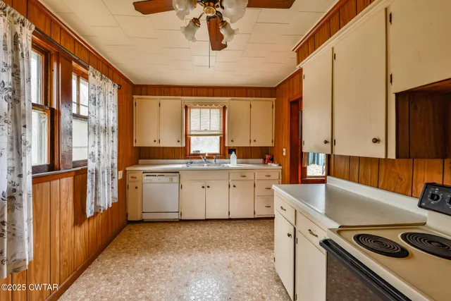 a kitchen that has a sink a stove and a microwave oven