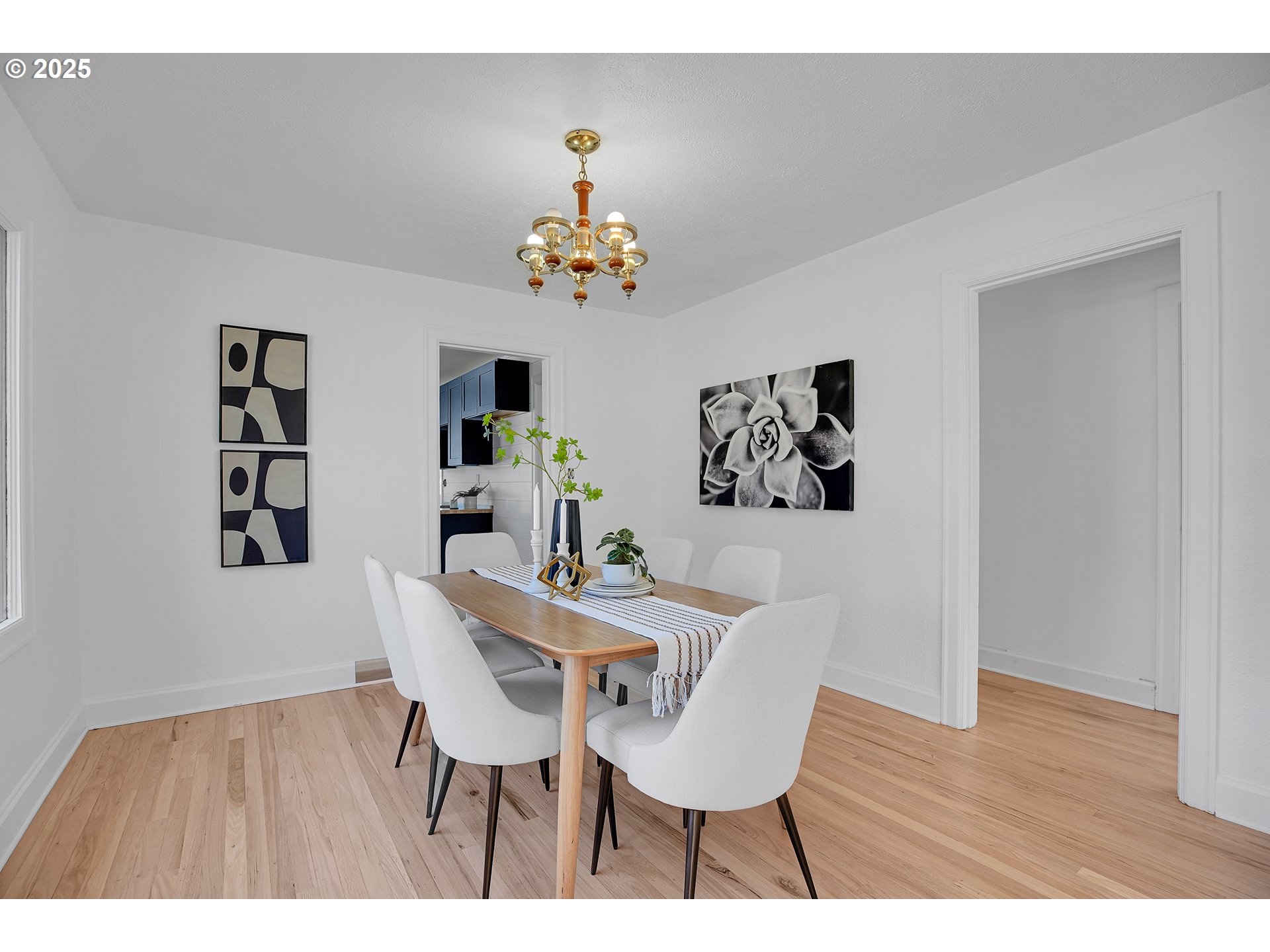 574 South Ivy Street Canby, OR 97013 - Photo 16 of 41 a view of a dining room with furniture wooden floor and a chandelier