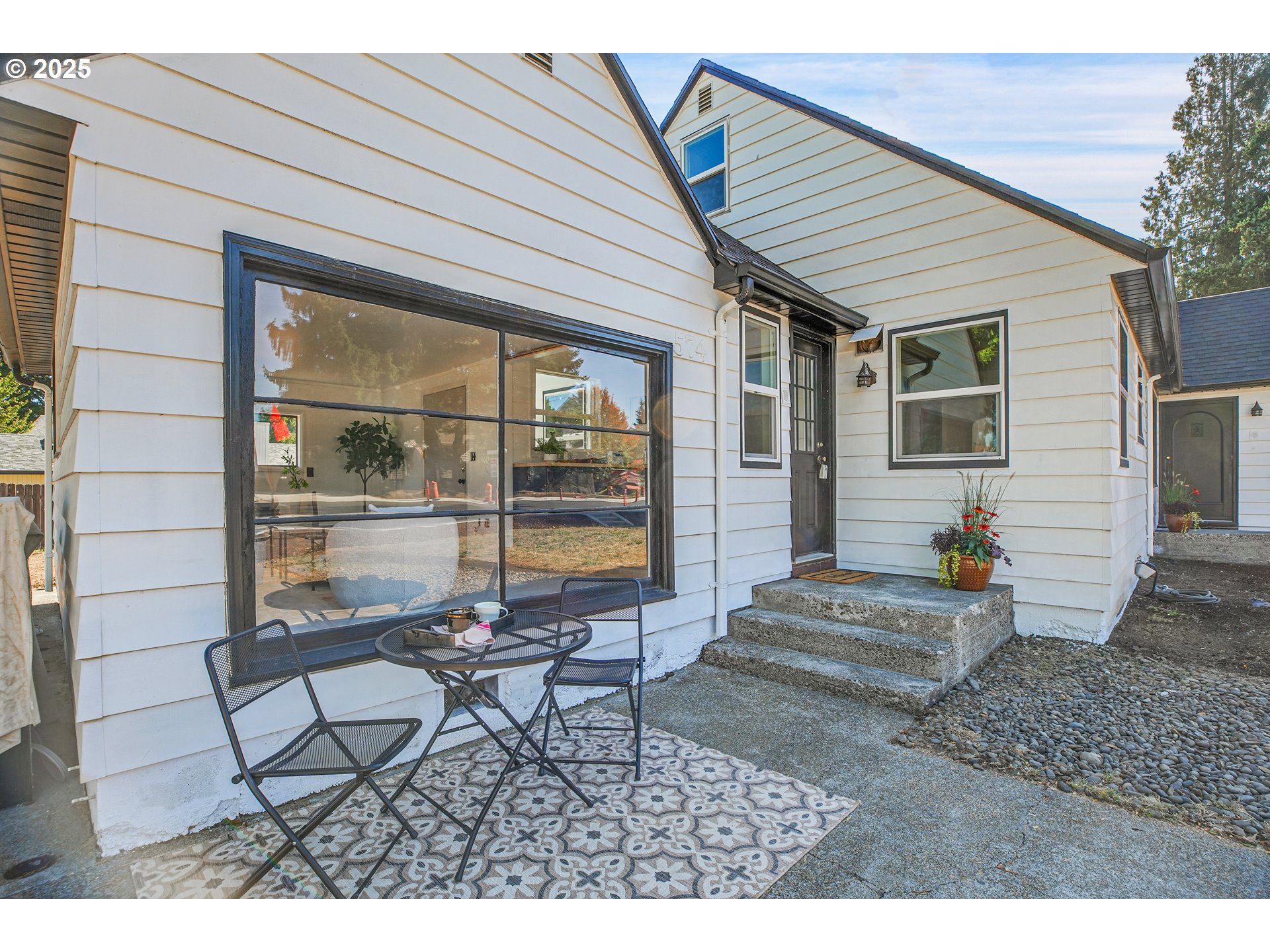 574 South Ivy Street Canby, OR 97013 - Photo 2 of 41 a backyard of a house with table and chairs