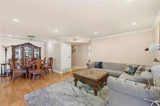 a living room with furniture wooden floor and a table