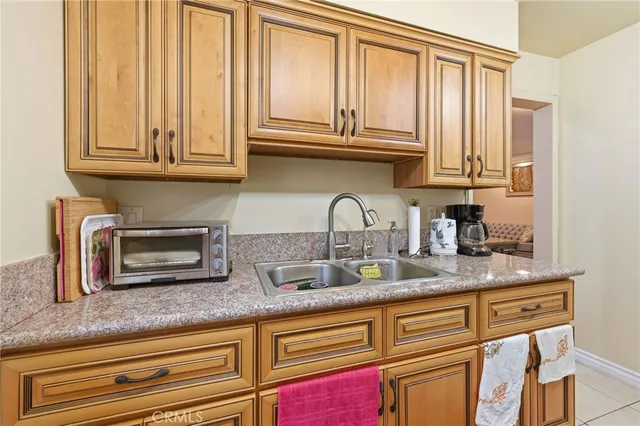 a kitchen with granite countertop stainless steel appliances a sink and cabinets