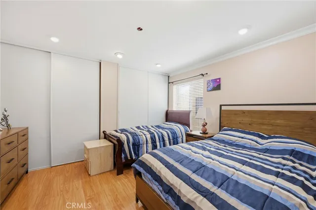 a spacious bedroom with two beds and painted walls