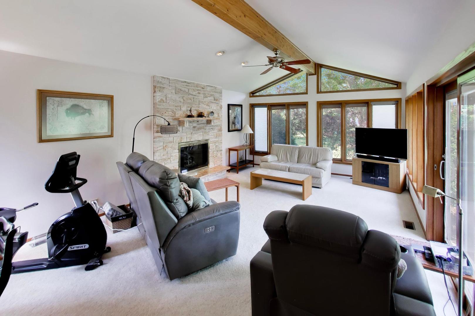 103 Cottonwood Road Northbrook, IL 60062 - Photo 14 of 50 a living room with furniture a flat screen tv and a fireplace